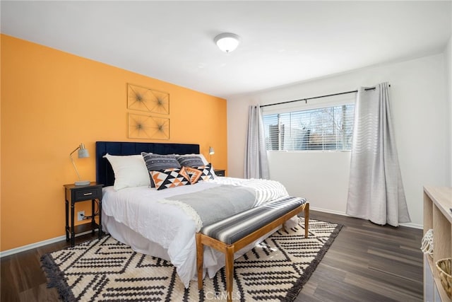 bedroom with dark hardwood / wood-style flooring