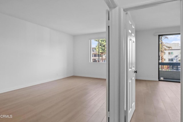 unfurnished room with light hardwood / wood-style flooring and a healthy amount of sunlight