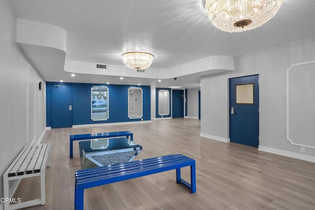 interior space featuring wood-type flooring and an inviting chandelier