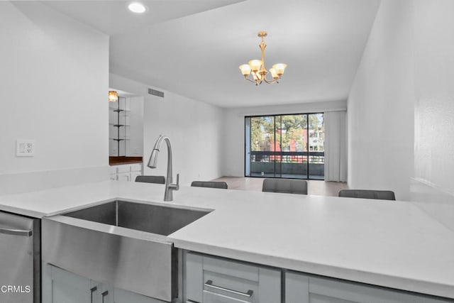 kitchen with dishwasher, an inviting chandelier, sink, hanging light fixtures, and gray cabinets