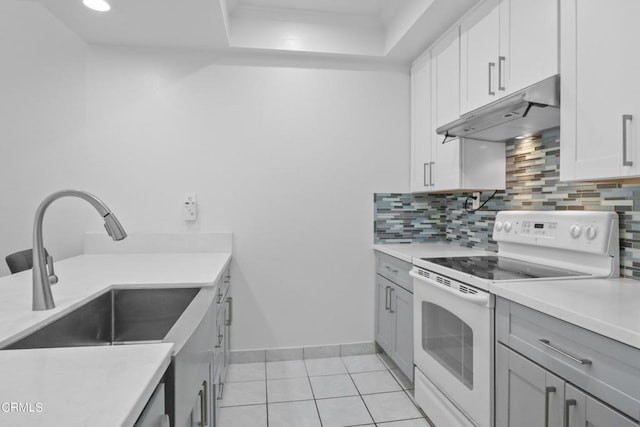 kitchen with white cabinets, sink, decorative backsplash, light tile patterned floors, and white electric range oven