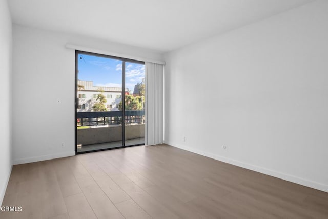 spare room featuring wood-type flooring