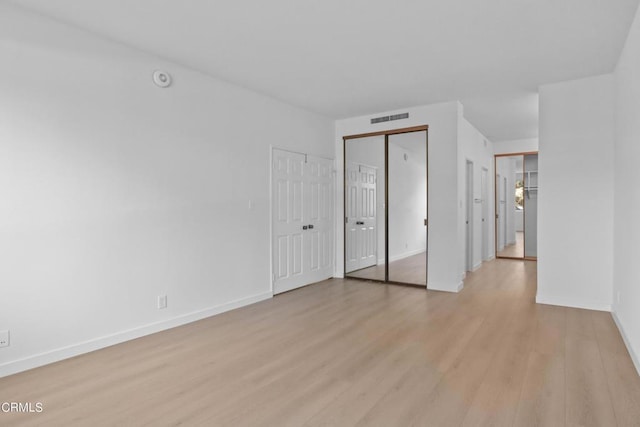 spare room with light hardwood / wood-style floors