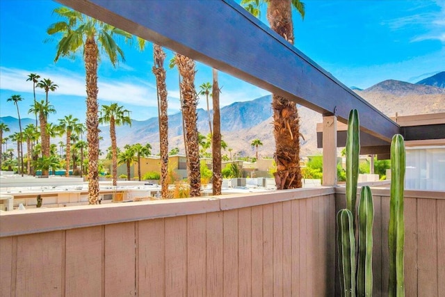 view of patio featuring a mountain view and a balcony