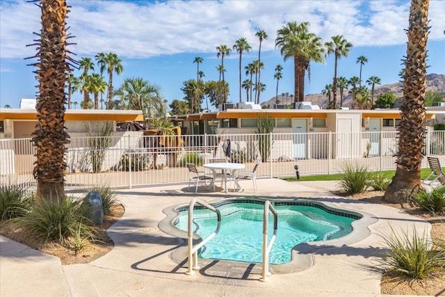 view of pool with a patio area and a hot tub