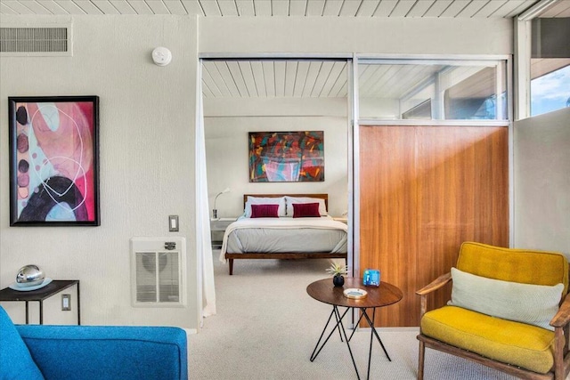 carpeted bedroom with wooden ceiling and heating unit