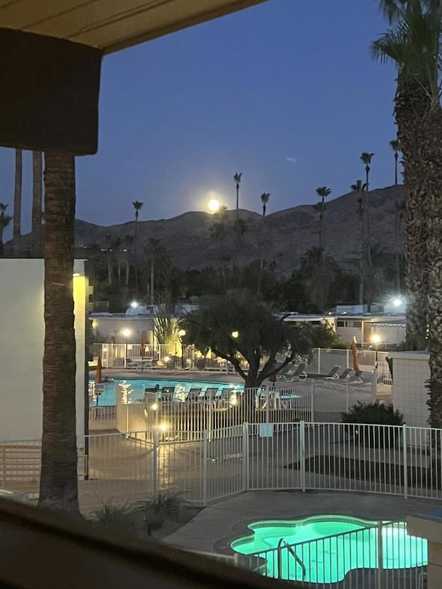 view of swimming pool featuring a mountain view and a patio area