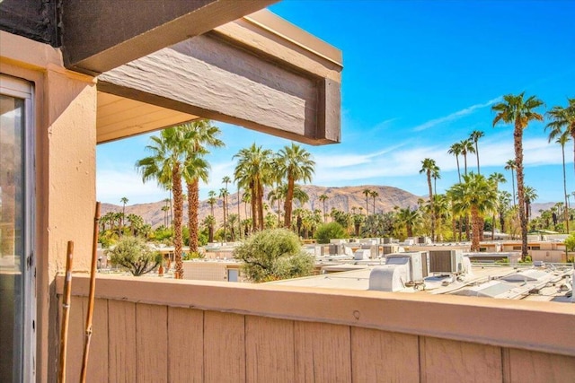 view of patio featuring a mountain view and a balcony