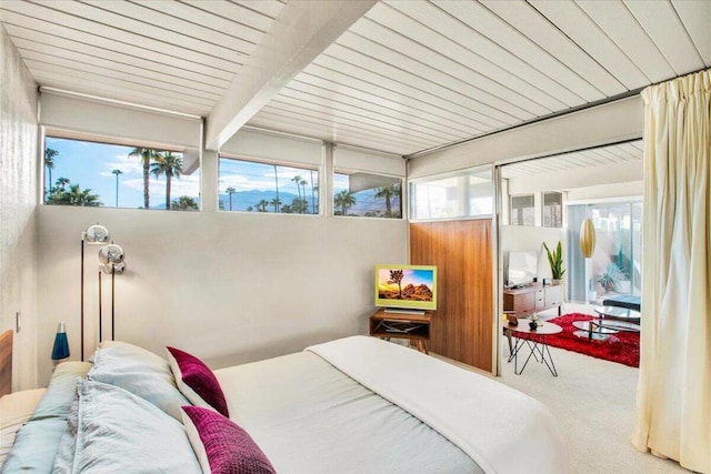 bedroom featuring carpet flooring, beamed ceiling, and wood ceiling