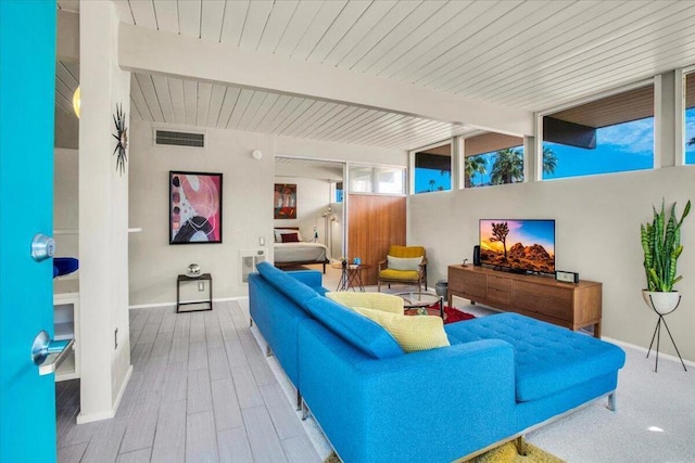 living room with hardwood / wood-style flooring and beam ceiling