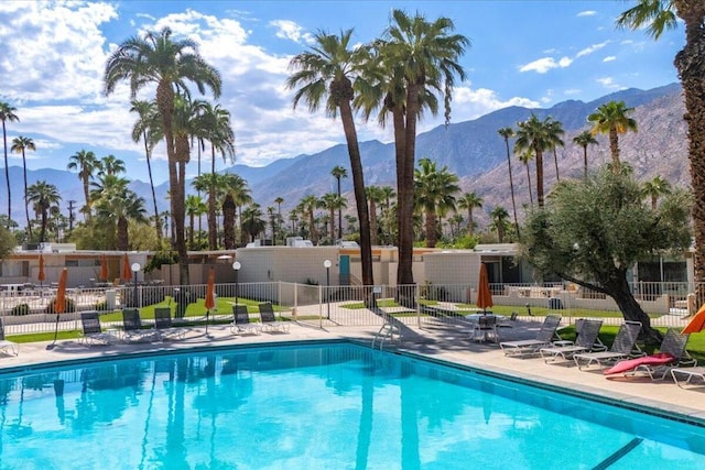 view of pool featuring a mountain view and a patio