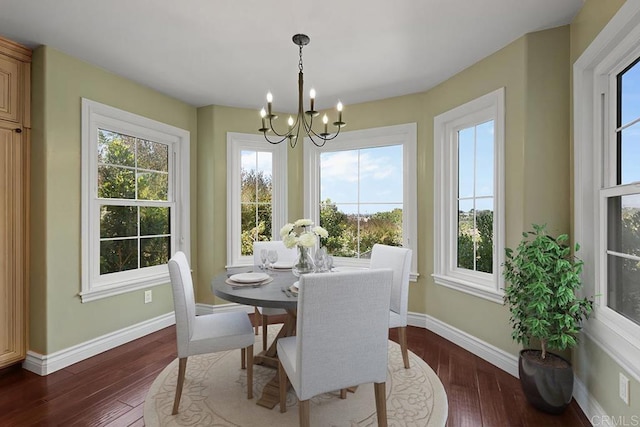 dining area with an inviting chandelier and dark wood-type flooring