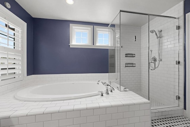 bathroom featuring shower with separate bathtub