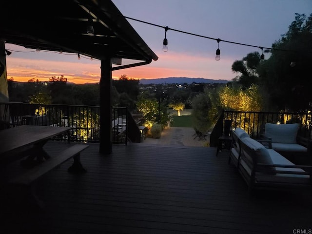 deck at dusk featuring outdoor lounge area