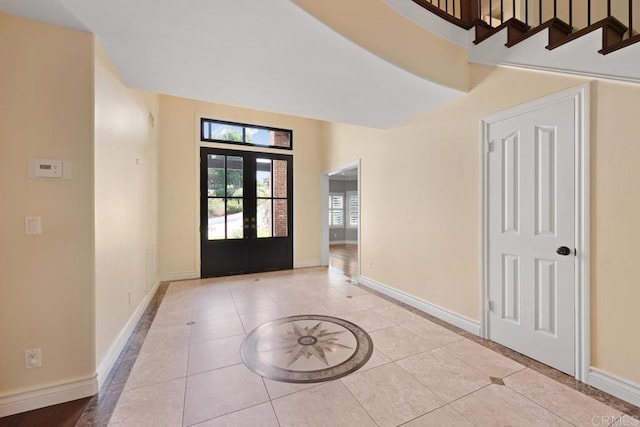 tiled entrance foyer featuring french doors