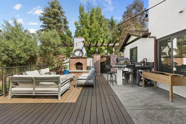 wooden terrace with an outdoor living space with a fireplace