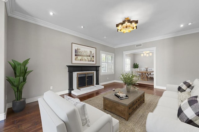 living room with crown molding, dark hardwood / wood-style flooring, and a notable chandelier