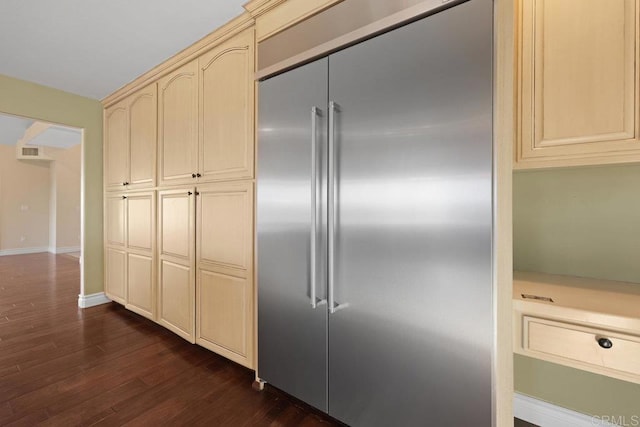 kitchen featuring cream cabinets, dark hardwood / wood-style flooring, and stainless steel built in fridge