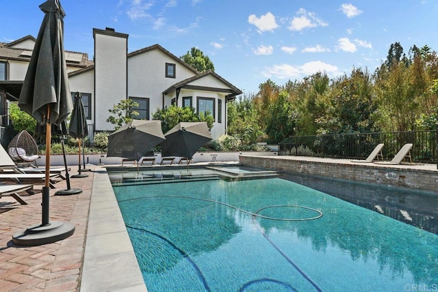 view of swimming pool with a patio area