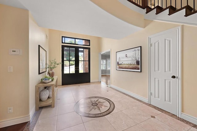 entryway with french doors and light tile patterned floors