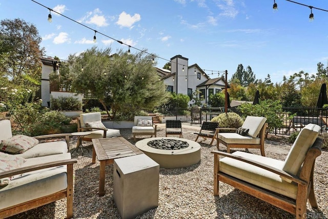 view of patio with an outdoor living space with a fire pit