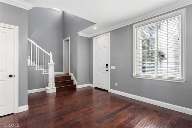 foyer entrance with dark hardwood / wood-style flooring and ornamental molding