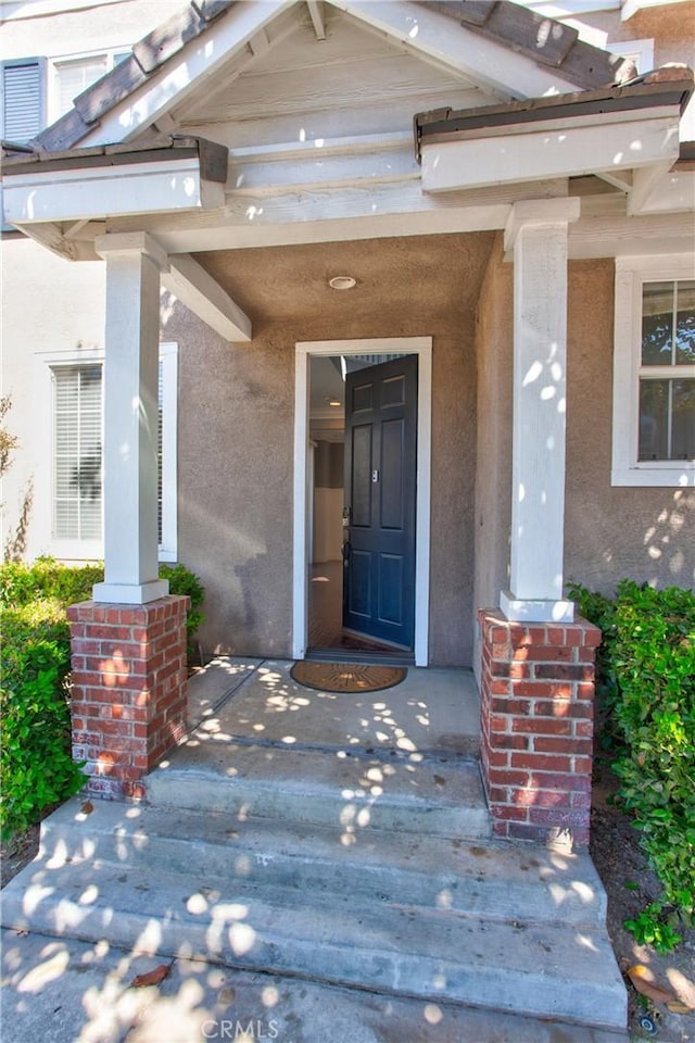 view of exterior entry with covered porch