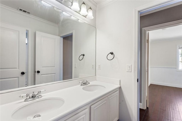 bathroom featuring vanity, wood-type flooring, and ornamental molding