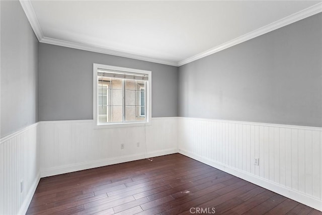 spare room featuring crown molding and dark wood-type flooring