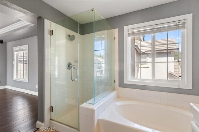 bathroom featuring hardwood / wood-style floors, shower with separate bathtub, and plenty of natural light