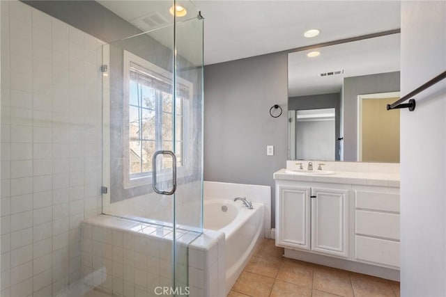 bathroom with tile patterned flooring, vanity, and independent shower and bath