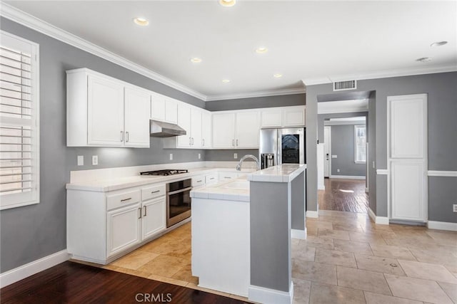 kitchen featuring white cabinets, stainless steel appliances, and a wealth of natural light