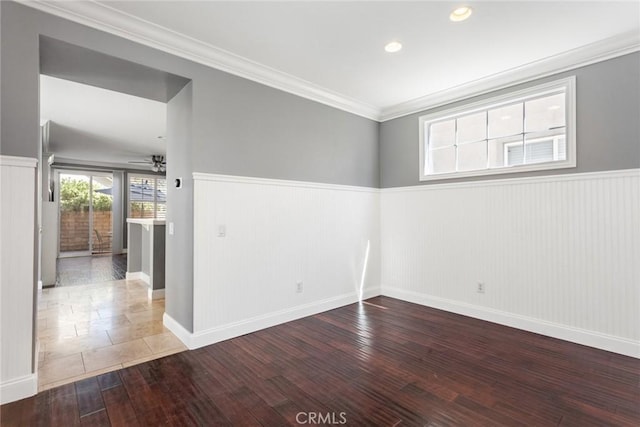 unfurnished room with hardwood / wood-style flooring, ceiling fan, and ornamental molding