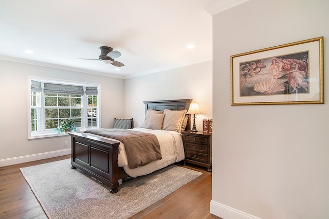 bedroom with crown molding, ceiling fan, and hardwood / wood-style flooring