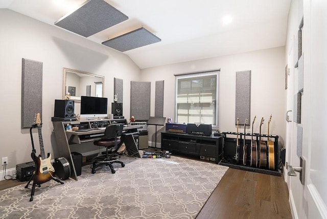 office featuring baseboards, lofted ceiling, and wood finished floors