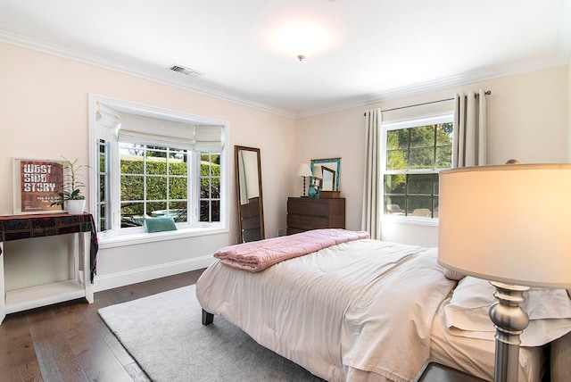 bedroom featuring multiple windows, ornamental molding, and dark hardwood / wood-style flooring