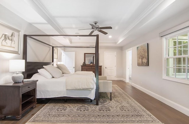 bedroom with dark wood-style floors, baseboards, recessed lighting, ornamental molding, and a raised ceiling