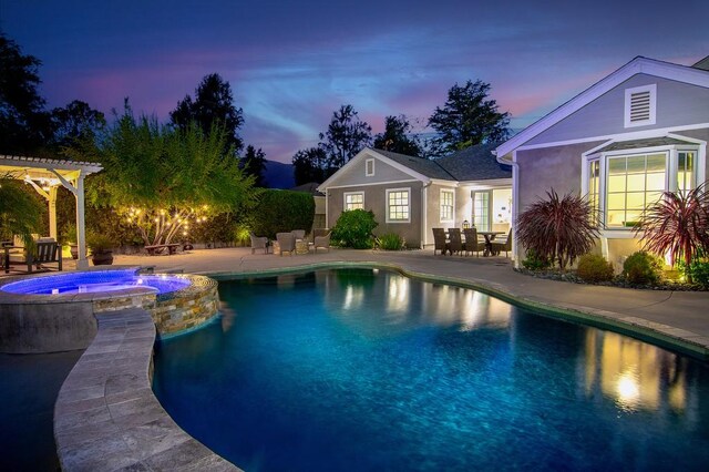 pool at dusk featuring a pergola, an in ground hot tub, and a patio area