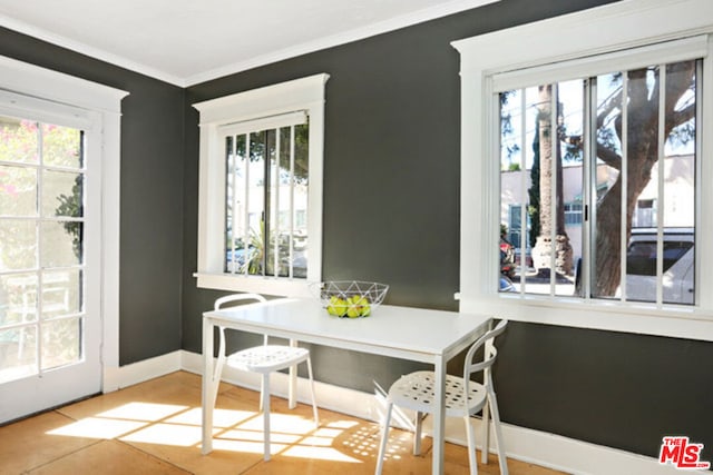 dining space with crown molding