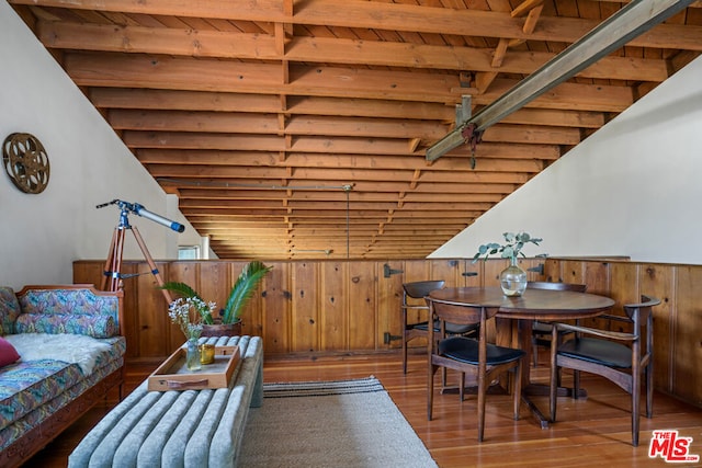 interior space featuring wood walls, wood ceiling, beam ceiling, and hardwood / wood-style floors