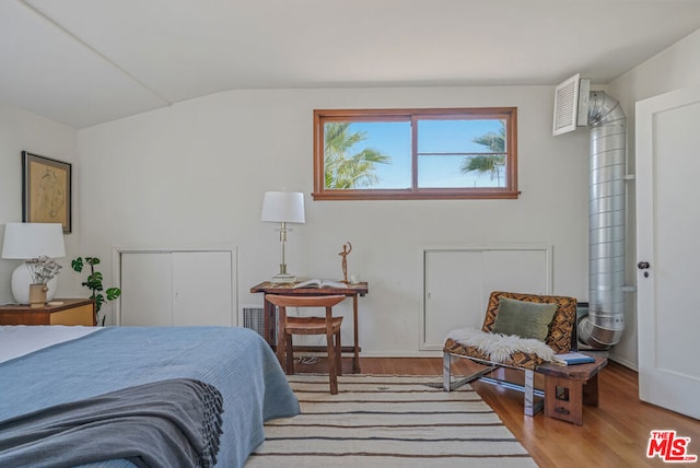 bedroom featuring vaulted ceiling and light hardwood / wood-style flooring