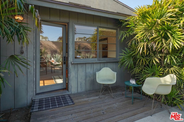 view of exterior entry with a wooden deck