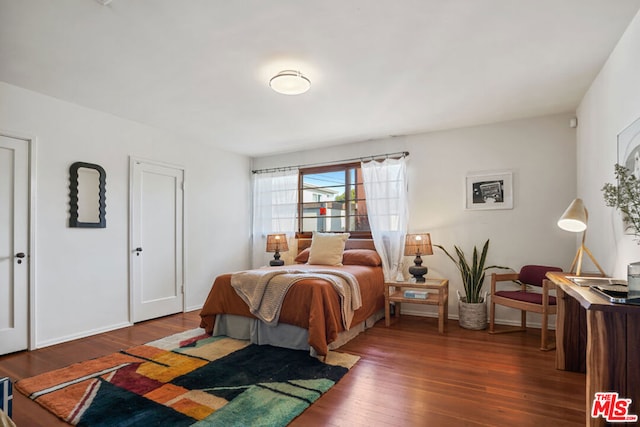 bedroom featuring dark wood-type flooring