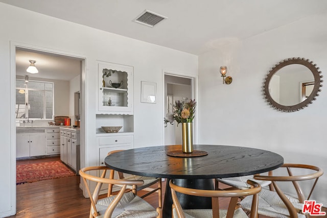 dining area featuring dark wood-type flooring