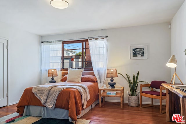 bedroom with hardwood / wood-style floors