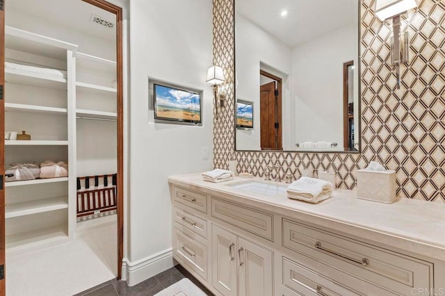 bathroom with backsplash, vanity, and tile patterned floors