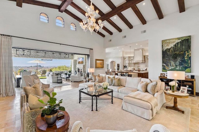 living room with high vaulted ceiling, a wealth of natural light, beam ceiling, and a chandelier