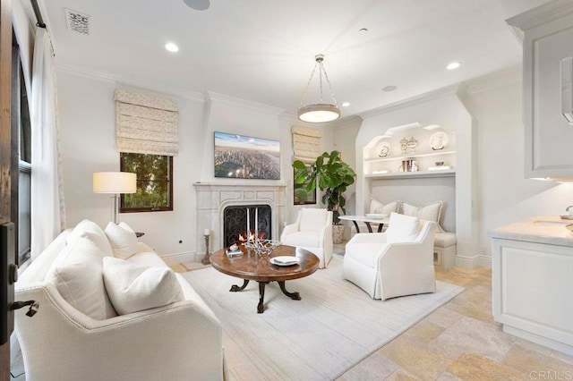 living room with ornamental molding and a premium fireplace