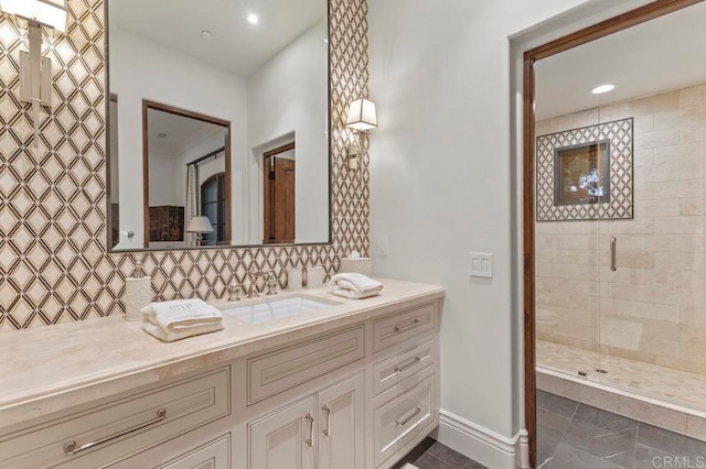 bathroom featuring decorative backsplash, vanity, and a shower with shower door