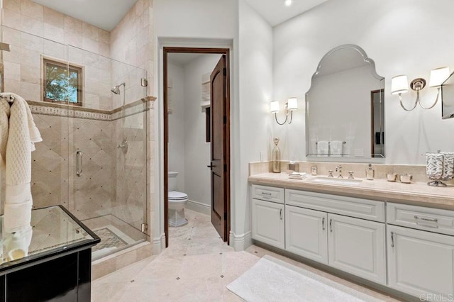 bathroom with vanity, toilet, and a shower with shower door